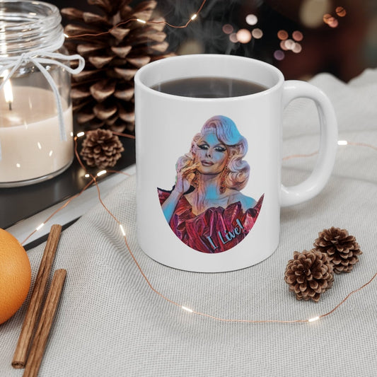 White 11 ounce ceramic mug with trinity the tuck and her catchphrase I live