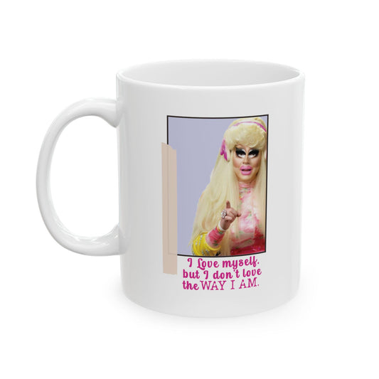 Trixie Mattel with long blonde hair and bold makeup pointing forward, with a quote in pink text reading: “I love myself, but I don’t love the way I am.”