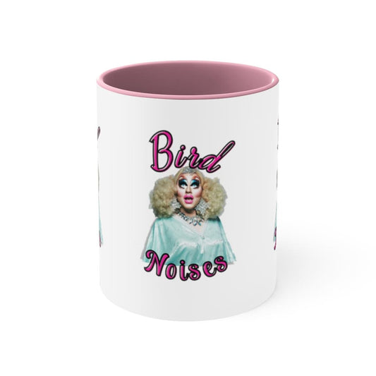 Two-tone ceramic coffee mug with colorful handle and interior, featuring a fun illustration inspired by Trixie Mattel that says bird noises