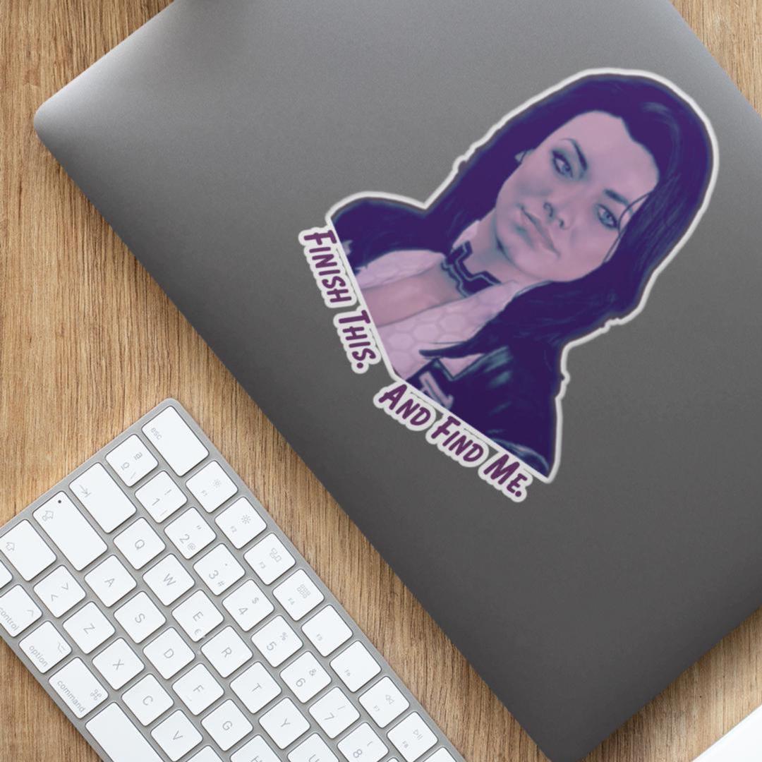 Vinyl sticker of Miranda Lawson from Mass Effect with the quote “Finish this. And find me.” in purple text on a white background.
