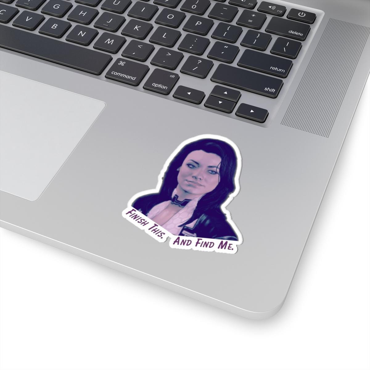 Vinyl sticker of Miranda Lawson from Mass Effect with the quote “Finish this. And find me.” in purple text on a white background.