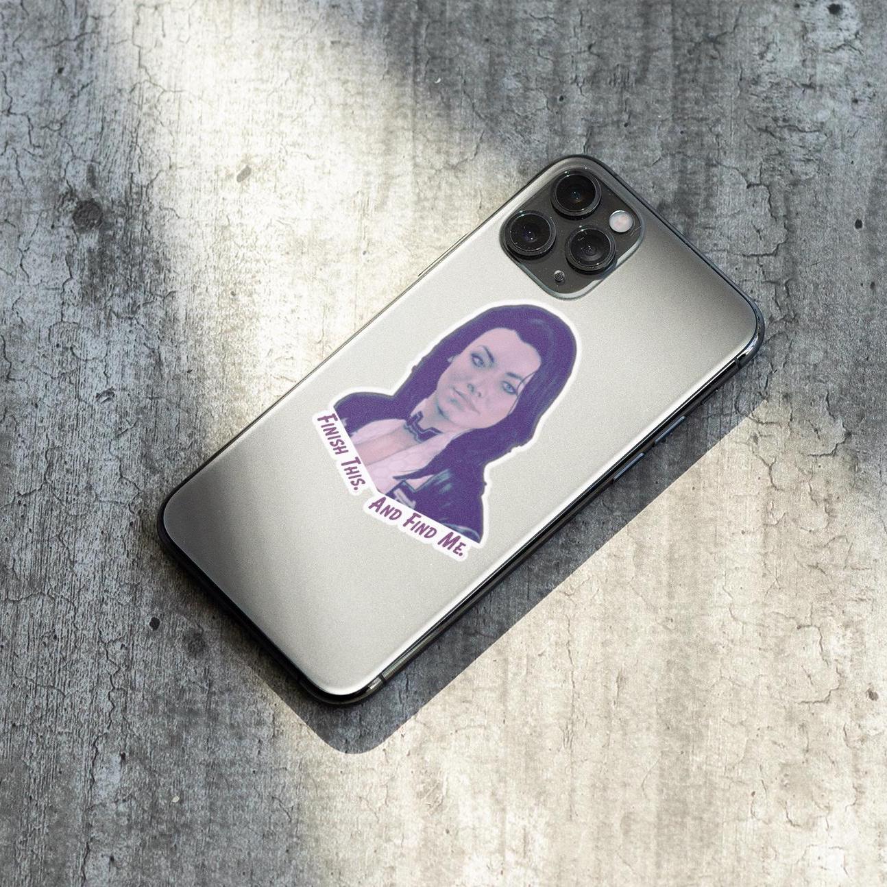 Vinyl sticker of Miranda Lawson from Mass Effect with the quote “Finish this. And find me.” in purple text on a white background.